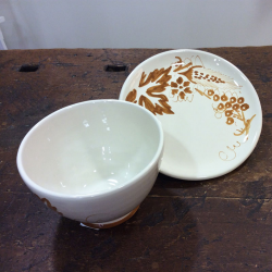 Bowl over ceramic saucer