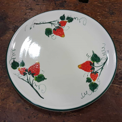 Round ceramic serving dish decorated with strawberries