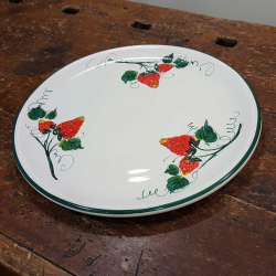 Round ceramic serving dish decorated with strawberries